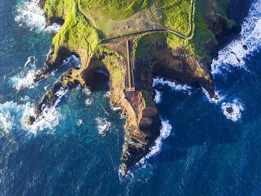 Aerial view of the coasts and cliffs of the island of Sao Miguel over the lighthouse of Farolim dos Fenais da Ajuda, Azores Islands, Portugal, Atlantic, Europe