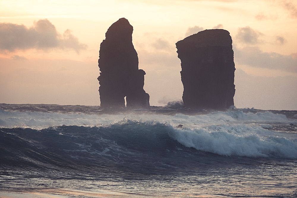 The sea stacks of Mosteiros at sunset with high waves in the foreground, Sao Miguel Island, Azores Islands, Portugal, Atlantic, Europe