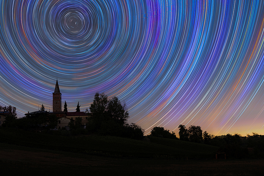 Concentric star trail over a bell tower in the Italian countryside, Emilia Romagna, Italy, Europe