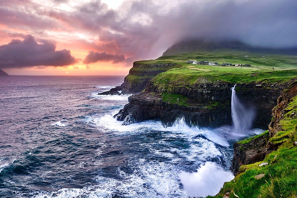 Sunset at the waterfall and cliffs of Gasadalur, Faroe Islands, Denmark, Europe