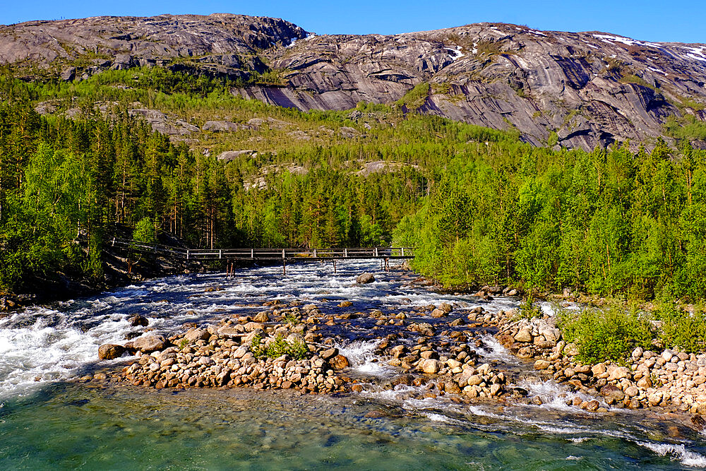 A pedestrian bridge extends over a glacial river, Tysfjord, Nordland, Norway, Scandinavia, Europe