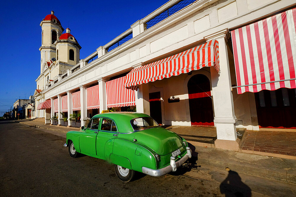 Vintage car parked along the street with Catedral de la Purisima Concepcion, Cienfuegos, UNESCO World Heritage Site, Cuba, West Indies, Central America