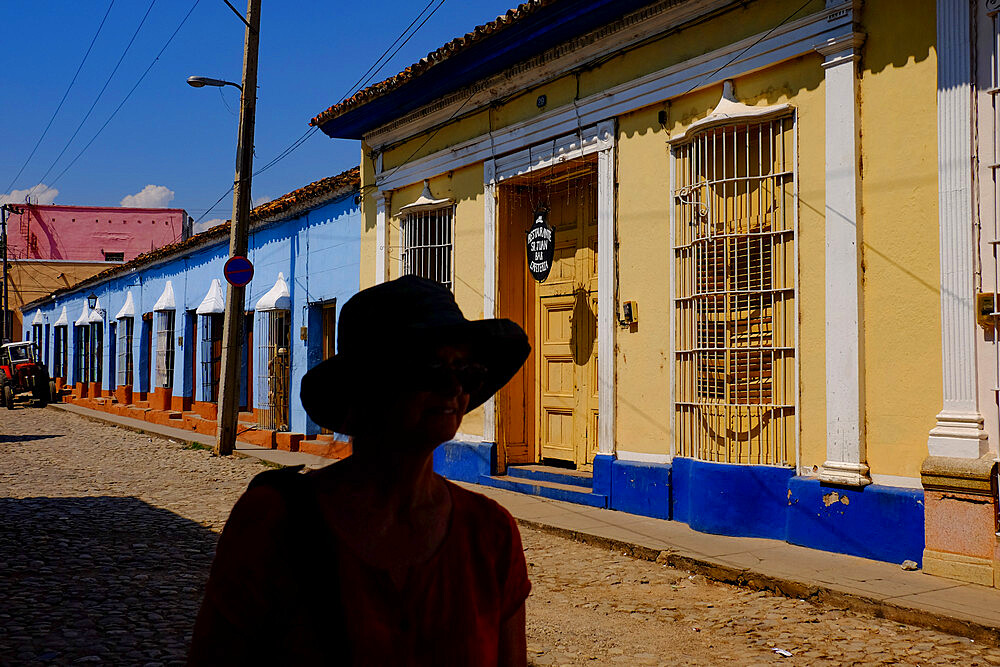 The silhouette of a woman on a quiet street, Trinidad, Sancti Spiritus, Cuba, West Indies, Central America