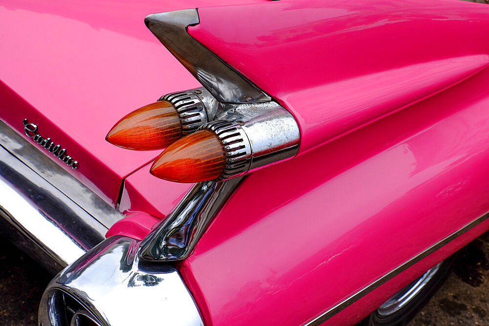 Rear fin and lights of vintage pink Cadillac, Havana, Cuba, West Indies, Central America