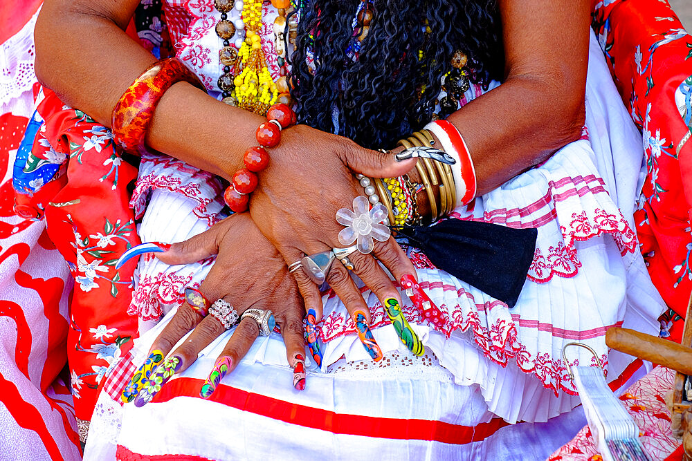 Colorful nails on the crossed hands of a lady in traditional dress, Old Havana, Cuba, West Indies, Central America