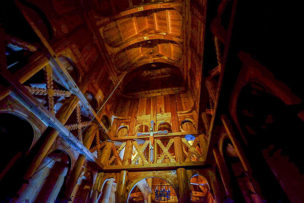 Fancy woodwork holds Jesus Christ on the Cross inside the Fantoft Stave church, Bergen, Norway, Scandinavia, Europe