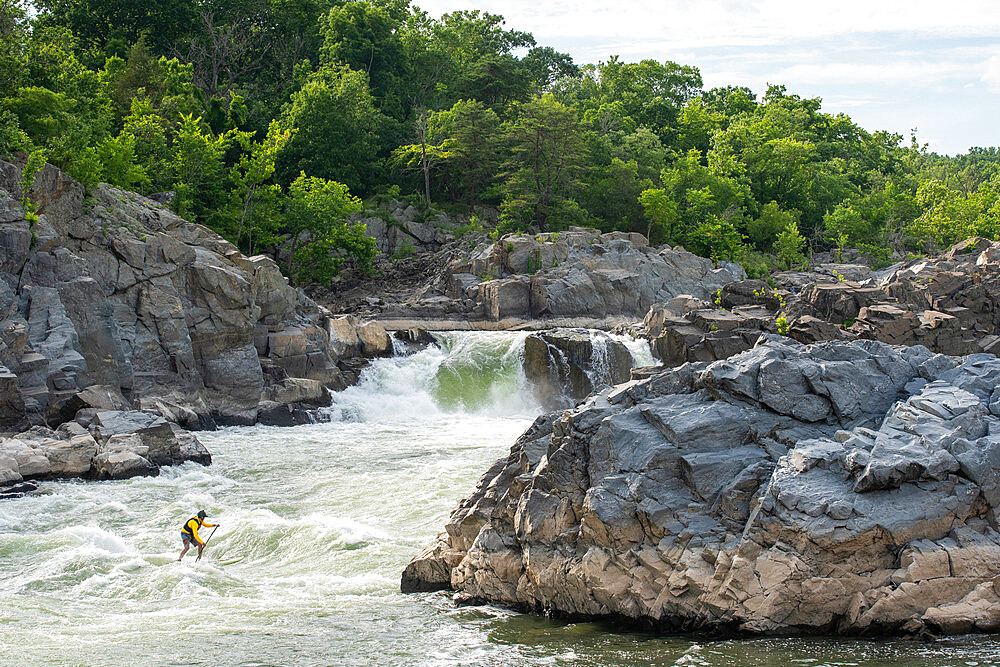 Ian Brown stand up paddle surfs challenging whitewater below Great Falls of the Potomac River, border of Maryland and Virginia, United States of America, North America