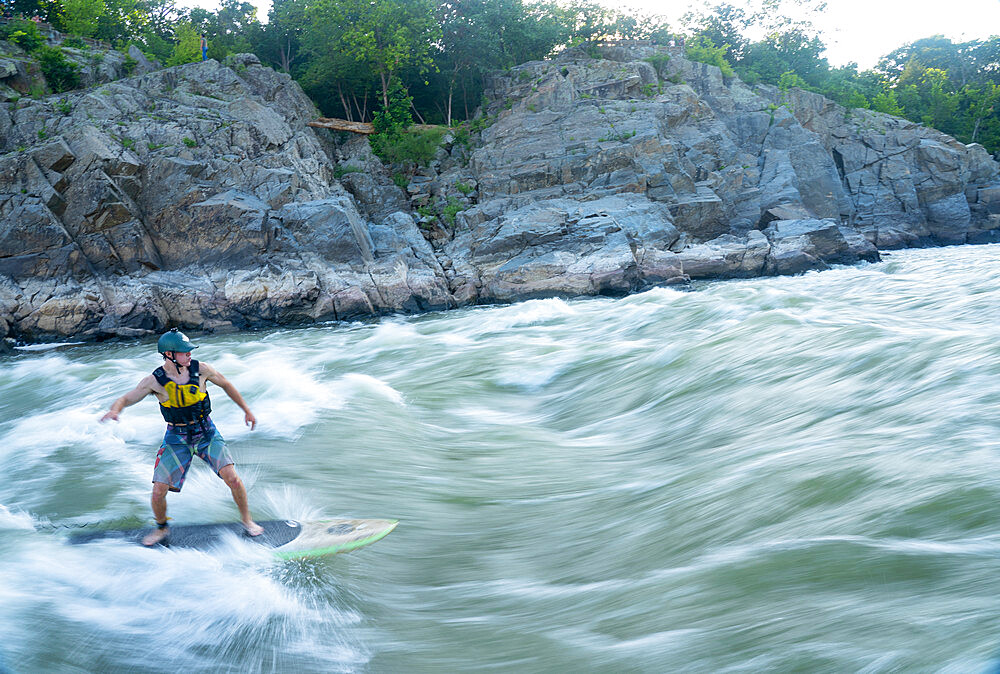 Ian Brown stand up paddle surfs challenging whitewater below Great Falls of the Potomac River, border of Maryland and Virginia, United States of America, North America