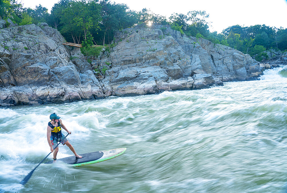 Ian Brown stand up paddle surfs challenging whitewater below Great Falls of the Potomac River, border of Maryland and Virginia, United States of America, North America