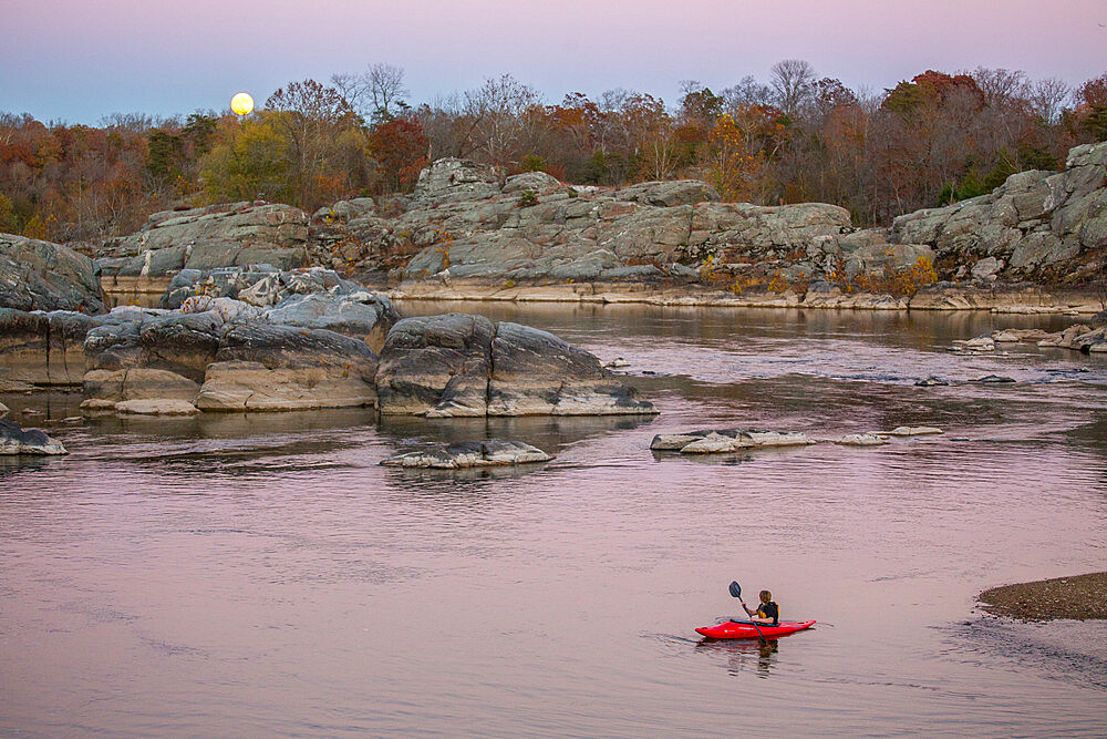 A kid paddles his kayak on the Potomac River at Cabin John, to watch the rising super moon of November 2016, Maryland, United States of America, North America