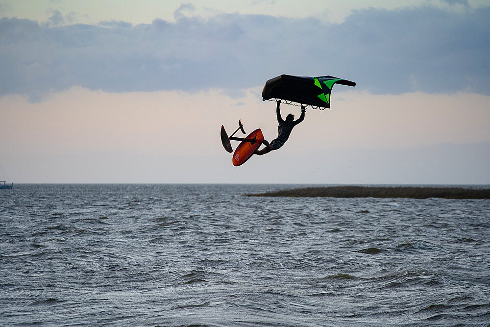 Pro surfer James Jenkins jumps his wing surfer over the Pamlico Sound at Nags Head, North Carolina, United States of America, North America