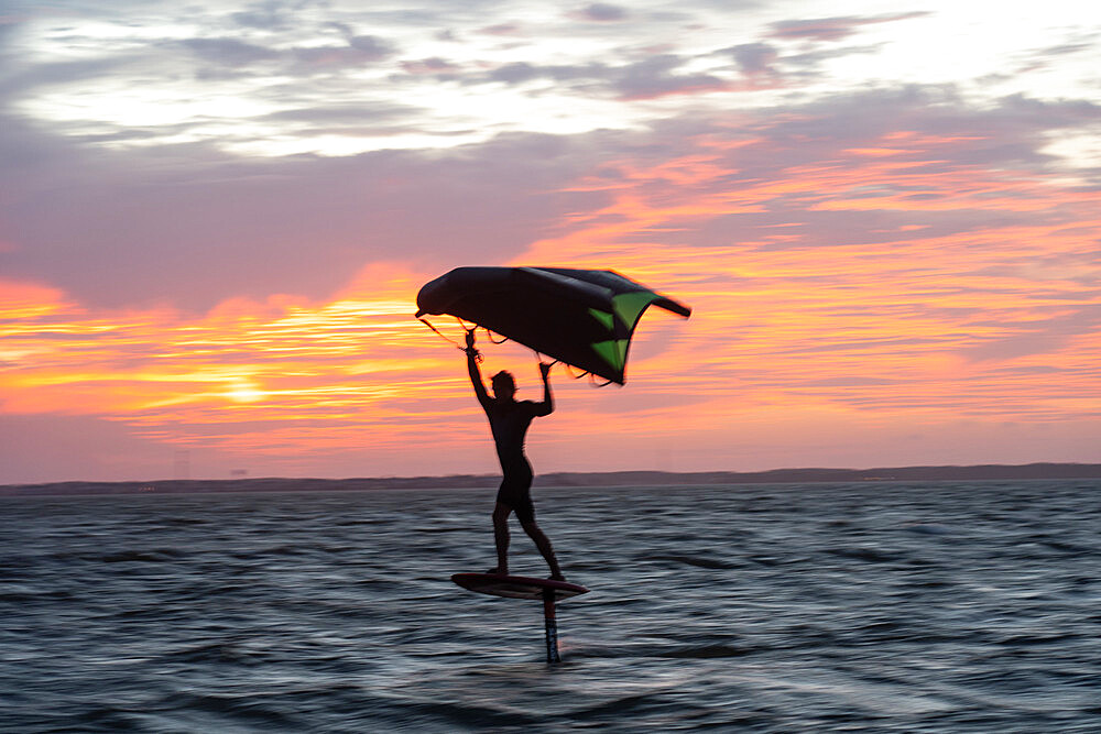 Pro surfer James Jenkins on his wing surfer flies across the Pamlico Sound at Nags Head, North Carolina, United States of America, North America