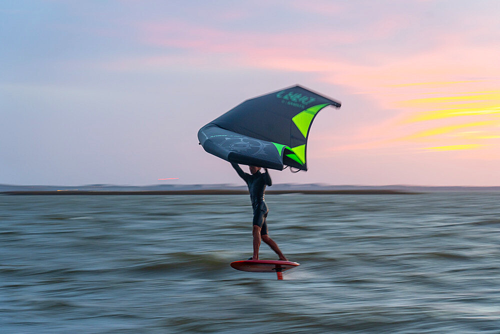 Pro surfer James Jenkins on his wing surfer flies across the Pamlico Sound at Nags Head, North Carolina, United States of America, North America