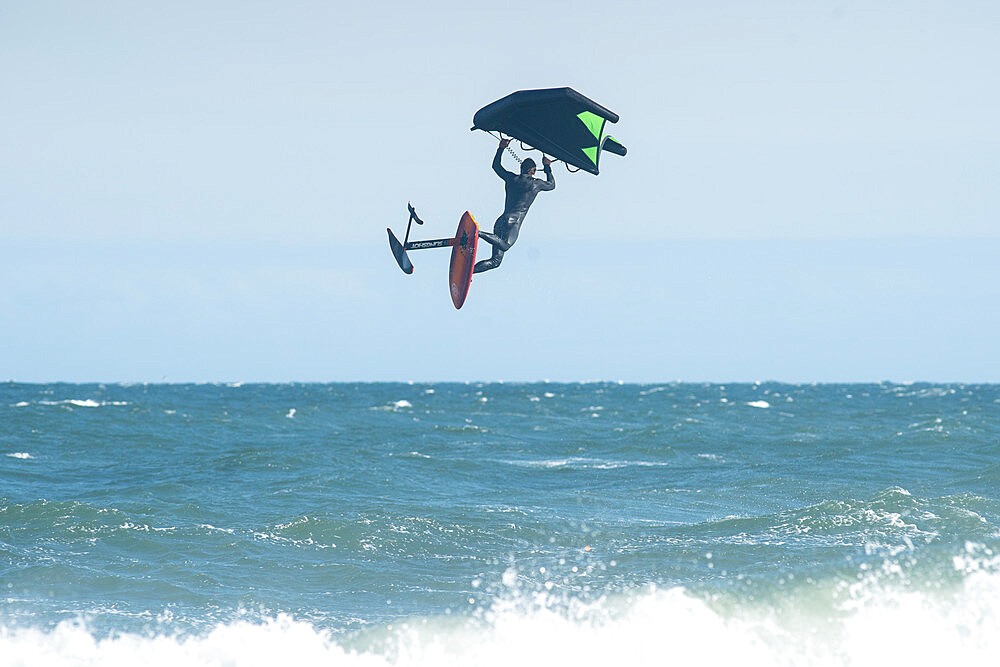 Pro surfer James Jenkins flies above the Atlantic Ocean on his wing surfer at Nags Head, North Carolina, United States of America, North America