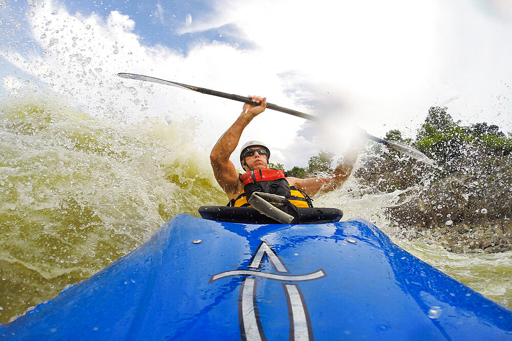 Photographer Skip Brown surfs his whitewater kayak through big water on the Potomac River below Great Falls, Virginia, United States of America, North America