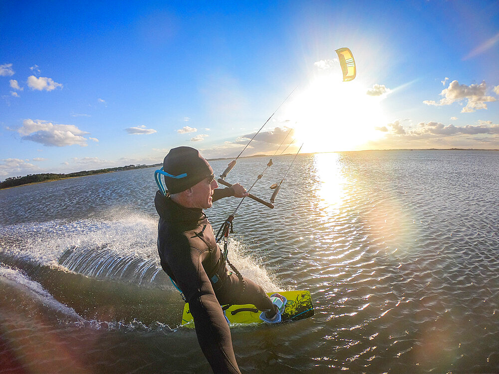 Photographer Skip Brown kiteboards on flat water on the Chesapeake Bay at Hampton, Virginia, United States of America, North America