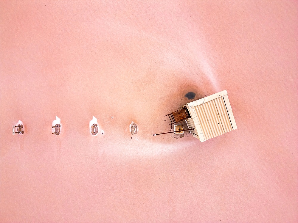 Tuz salt lake drone aerial view of house in the lake with pink salt around, in Turkey