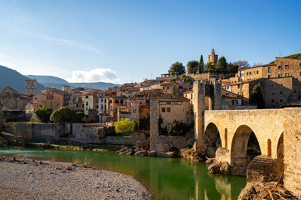 Besalu historic medieval city with Catalonia flags on the stone bridge tower crossing El Fluvia river, Besalu, Catalonia, Spain, Europe