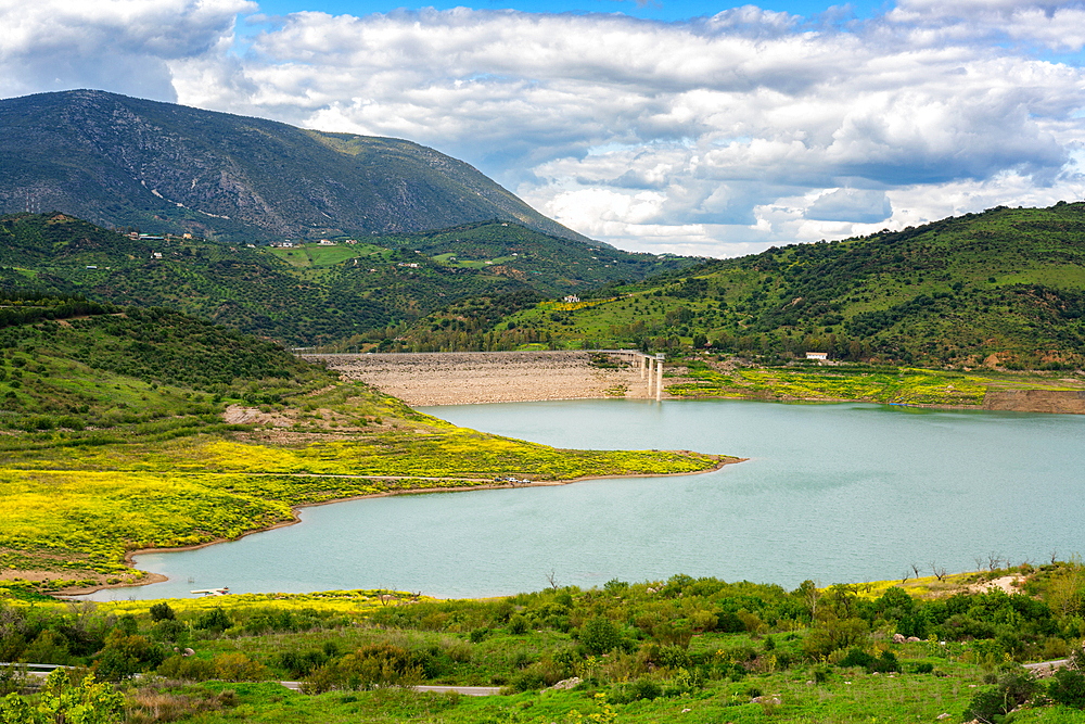 Zahara de la Sierra water reservoir dam with turquoise water and mountains in the background, Andalusia, Spain, Europe