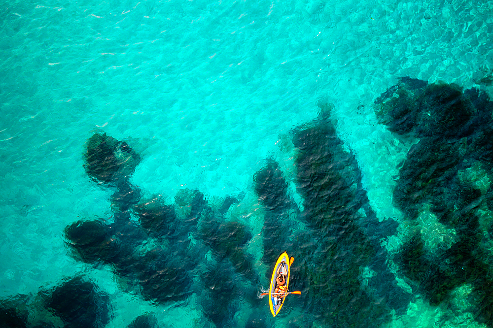 Aerial drone above view of a kayak on the turquoise water of Mediterranean Sea, Sardinia, Italy, Mediterranean, Europe