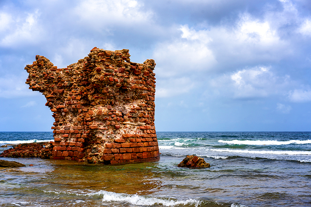 Historic tower of Porto Paglia in the sea on the coast of Sardinia, Italy, Mediterranean, Europe