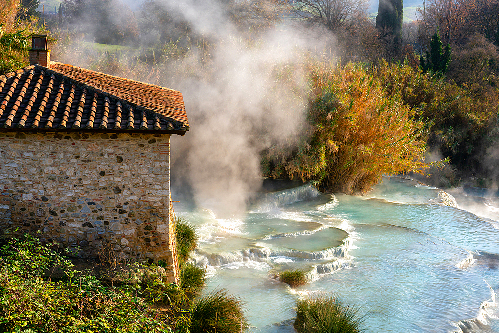 Saturnia hot springs with turquoise water and an old mill in Tuscany, Italy