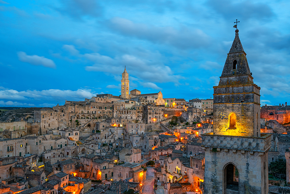 Ancient city view with traditional stone houses, Maria Santissima della Bruna and Sant'Eustachio Cathedral and Church of Saint Peter Barisano at sunset, Matera, Basilicata, Italy, Europe