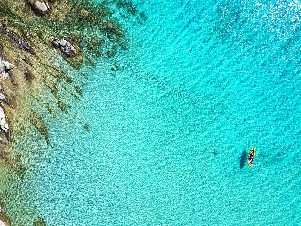 Diaporos island with wild beaches with turquoise water drone top aerial view in Greece