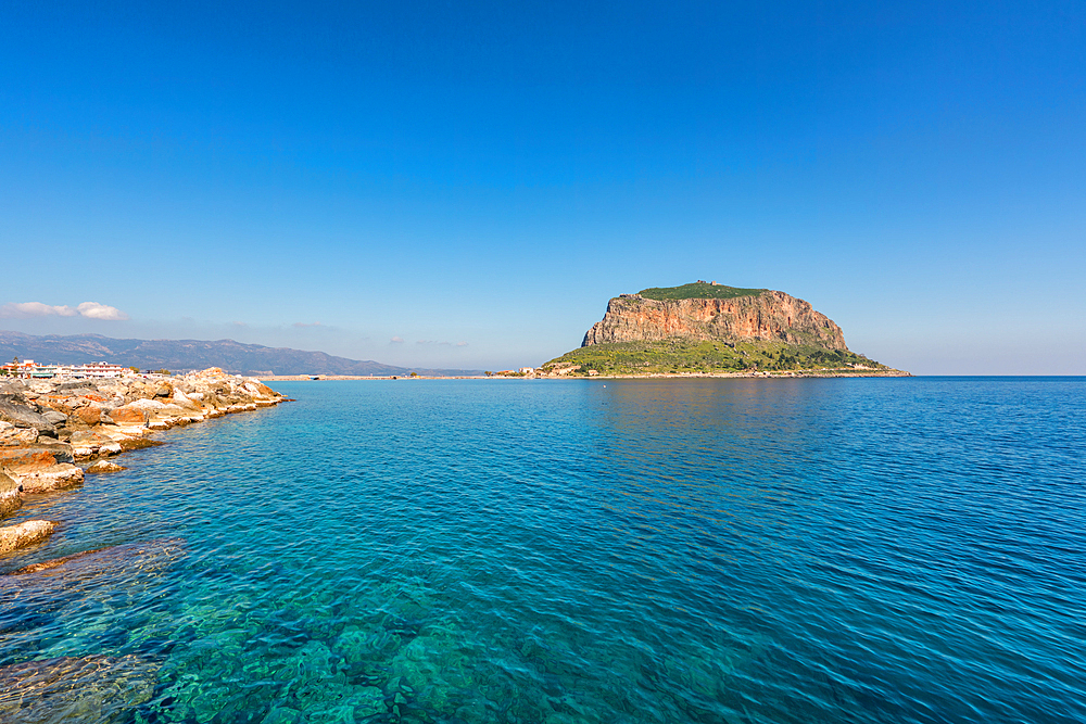 Monemvasia historic city on an island with a mountain in the middle of turquoise sea water, in Greece