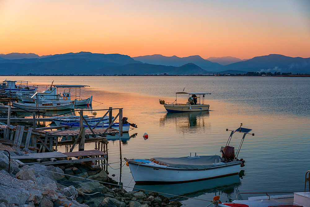 Nafplion port with fishermen boats at sunset in Greece