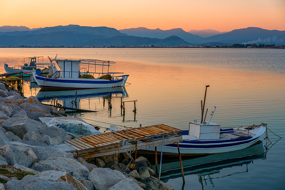 Nafplion port with fishermen boats at sunset in Greece