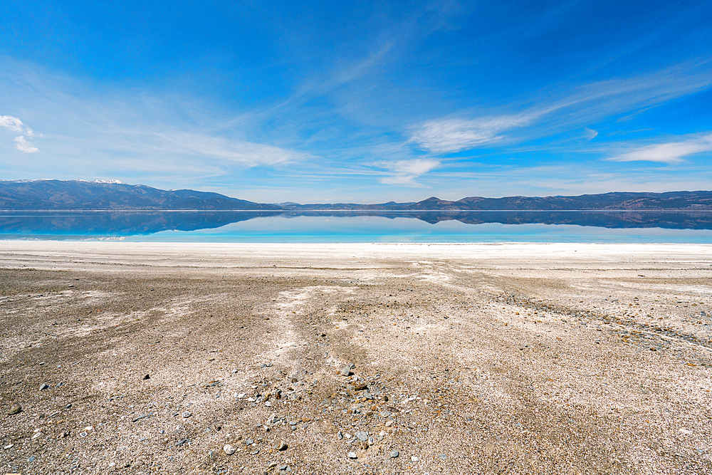 Salda lake with turquoise water and white sand and mountains at sunset in Turkey