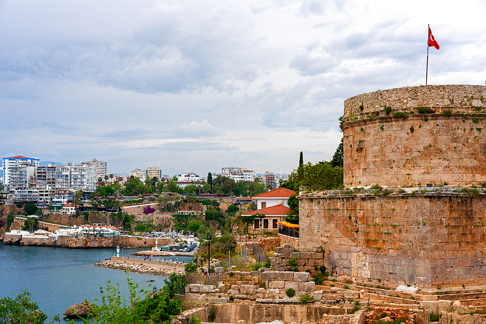 Hidirlik tower with Turkish flag waiving in the wind in Antalya, Turkey