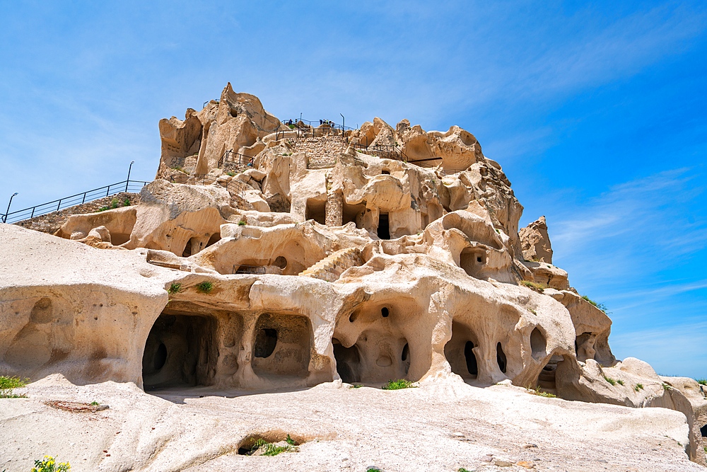 Uchisar town castle with caves inside a rock formation in Cappadocia, Turkey
