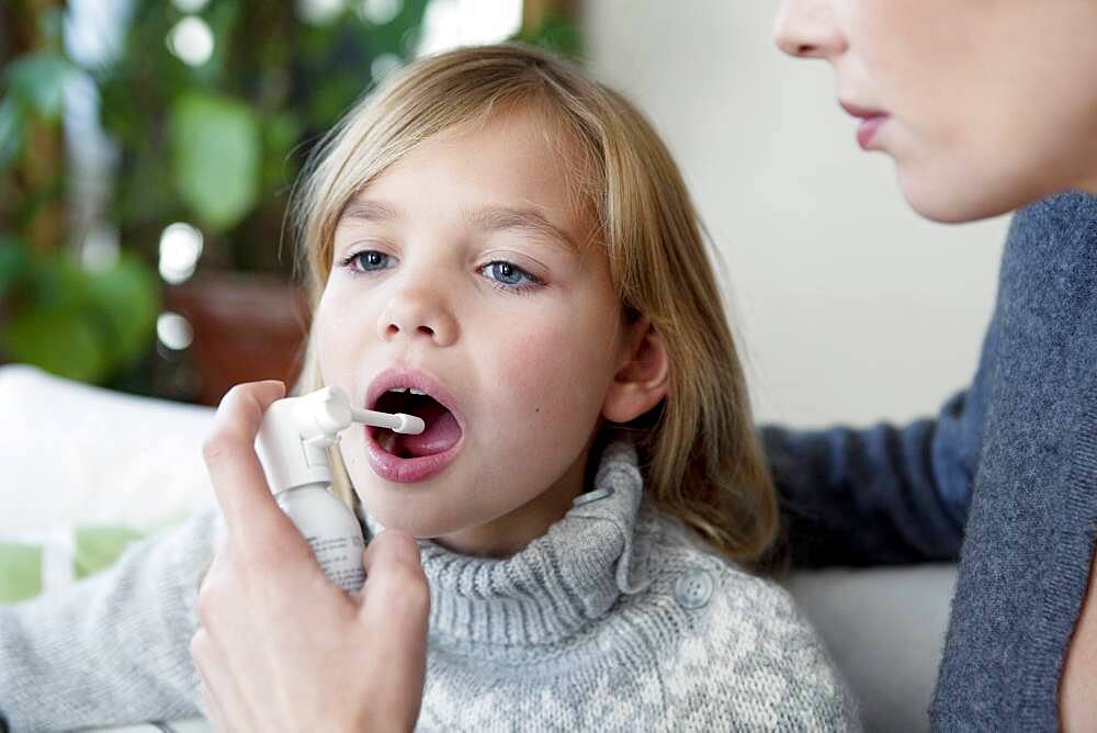 Child using spray in mouth