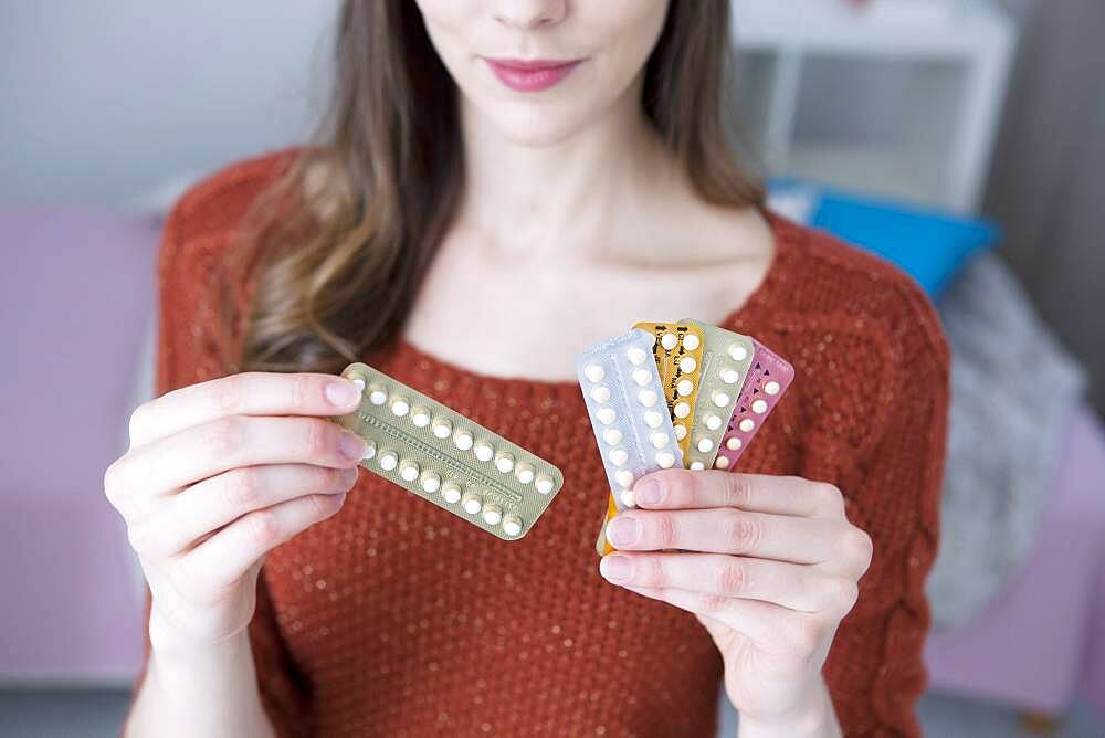 Woman holding contraceptive pills.