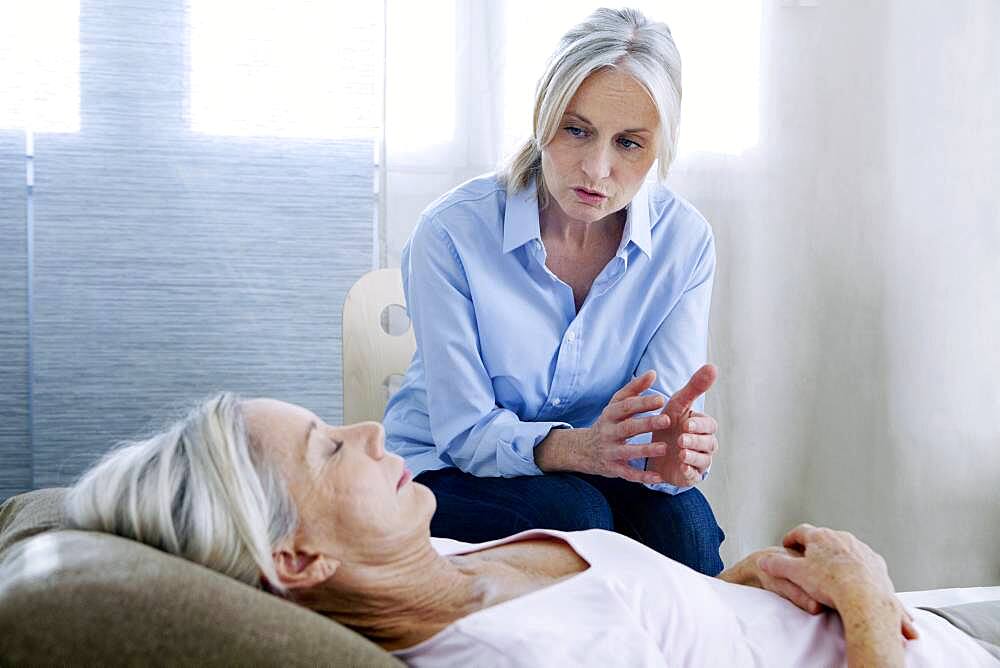 Senior woman undergoing hypnosis session.