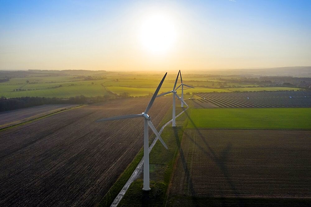 Commercial wind turbines at sunrise on a clear day