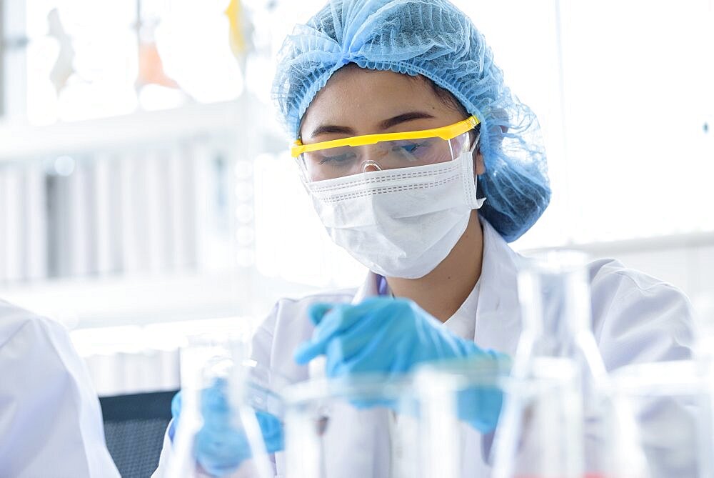 Asian young girl student scientist researching and learning in a laboratory.