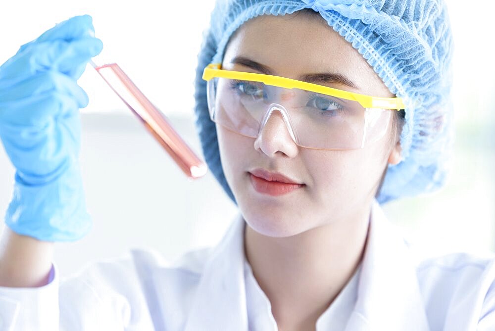 Asian young girl student scientist researching and learning in a laboratory.