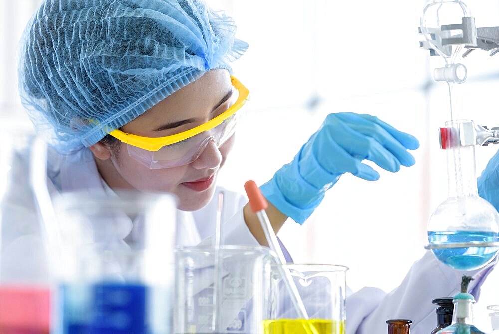 Asian young girl student scientist researching and learning in a laboratory.