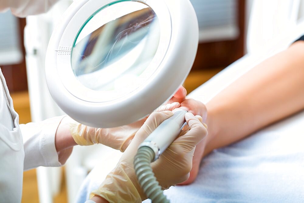 Woman receiving podiatry treatment in Day Spa.