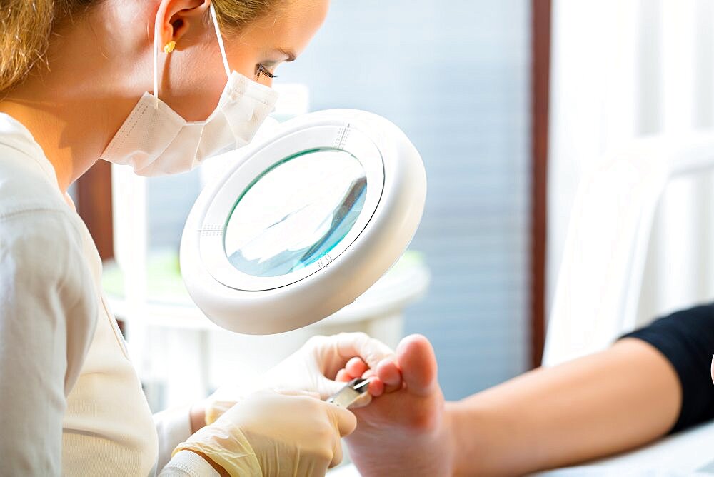 Woman receiving podiatry treatment in a Day Spa.