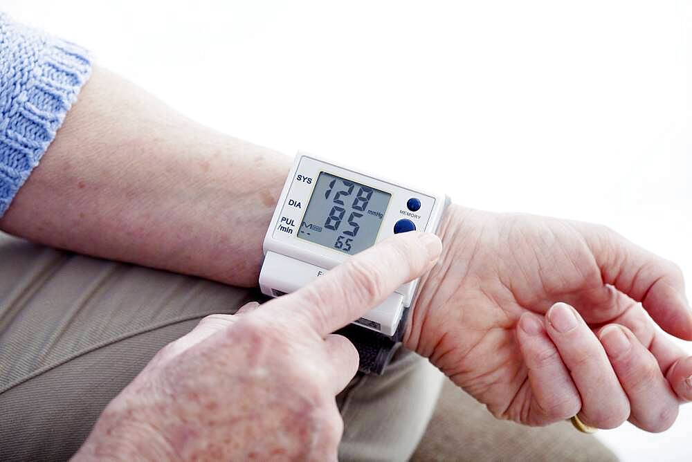 Senior woman measuring her blood pressure.