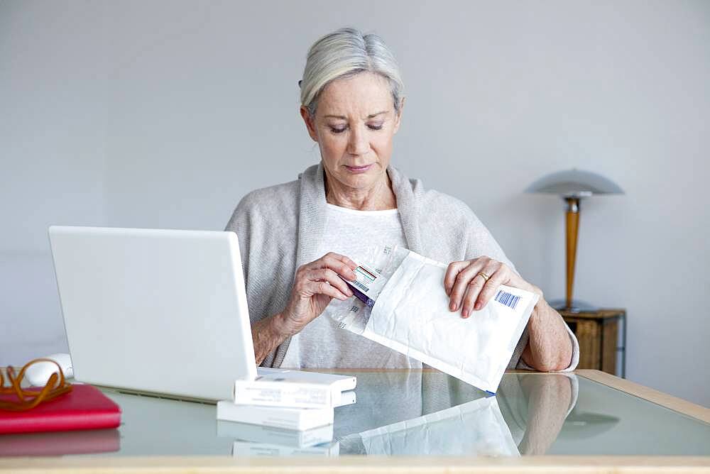 Senior woman receiving medicines bought on internet.