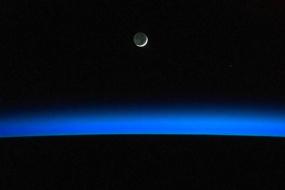 Crescent Moon Over Earth From ISS