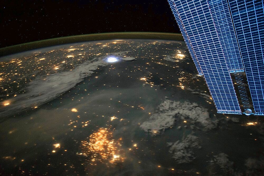 Lightning and city lights, ISS image