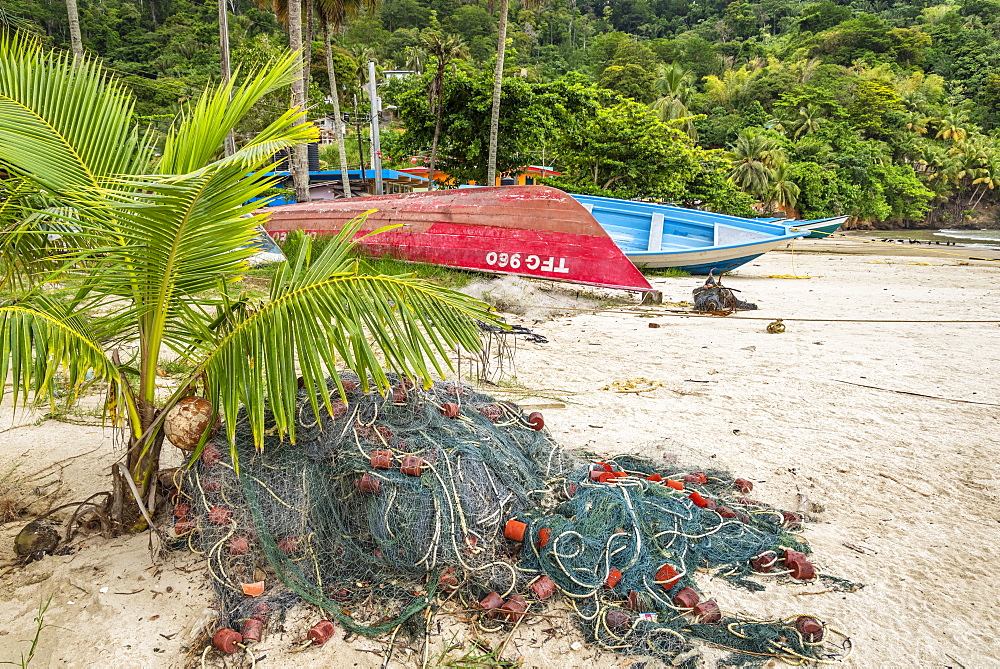 Fishing net and boats on the beach at Maracas Bay, Trinidad island, Trinidad and Tobago.