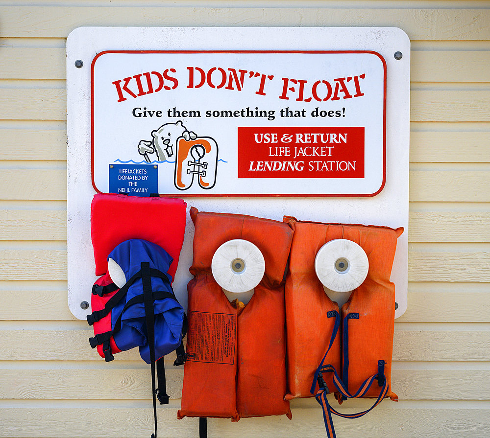 "Kids Don't Float" sign with life jackets to borrow on the dock in Old Town Florence on the central Oregon Coast.