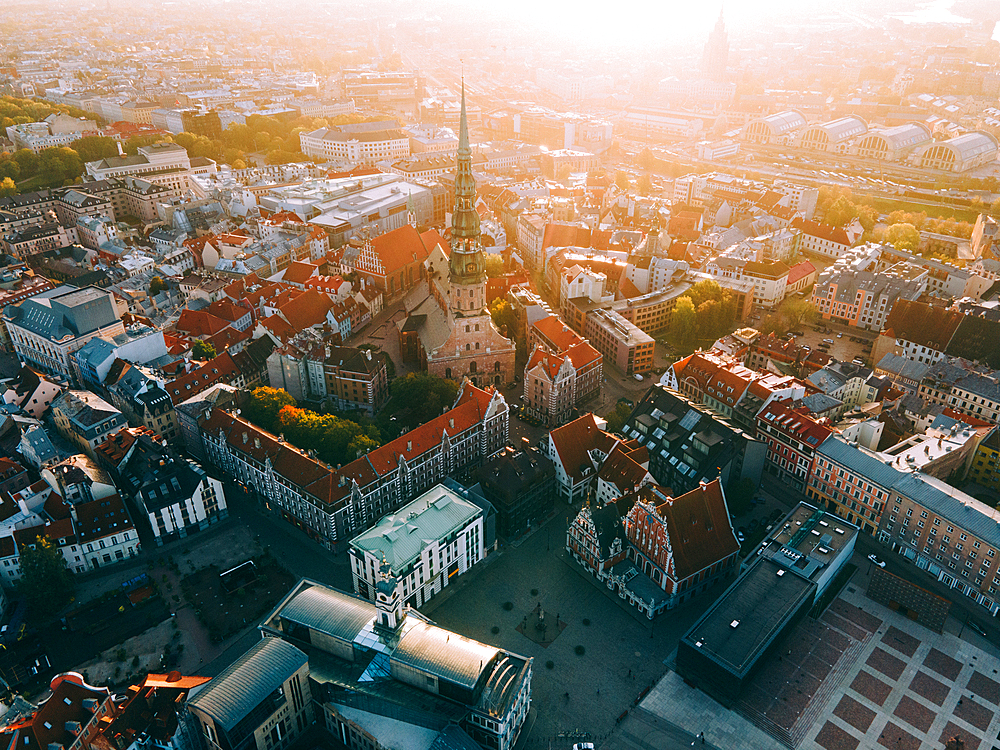 Aerial drone sunrise view of St. Peter's Church and House of the Black Heads, Riga Old Town (Vecriga), UNESCO World Heritage Site, Riga, Latvia, Europe